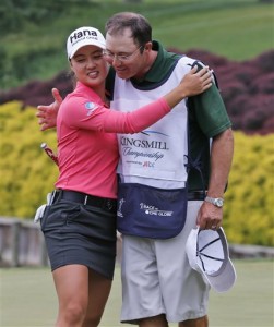 Minjee Lee, of Australia, left, hugs her caddie on the 18th hole after winning the the rain delayed Kingsmill Championship  LPGA golf tournament at the Kingsmill Golf Club in Williamsburg, Va., Monday, May 18, 2015.    (AP Photo/Steve Helber)