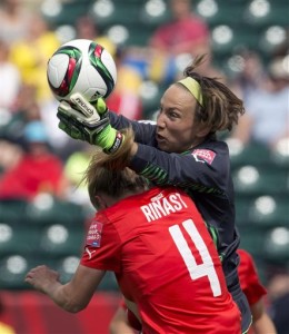 Switzerland goalie Gaelle Thalmann makes the save as Cameroon's Yvonne Leuko (4) challenges for the ball during the first half of a FIFA Women's World Cup soccer match, Tuesday, June 16, 2015 in Edmonton, Alberta, Canada. (Jason Franson/The Canadian Press via AP) MANDATORY CREDIT