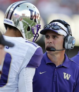 ADVANCE FOR WEEKEND EDITIONS, AUG. 29-30 - FILE - In this Nov. 15, 2014, file photo, Washington head coach Chris Petersen talks on then sideline during the first half of an NCAA college football game against Arizona in Tucson, Ariz. On Sept. 4, 2015, Peterson will return to Boise State where he coached for 13 years, as he leads Washington in their first game of the 2015 season. Surely, his return will be welcome, for awhile. (AP Photo/Rick Scuteri, File)
