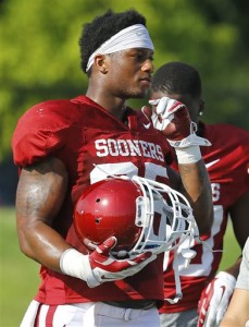 FILE - In this Aug. 10, 2015, file photo, Oklahoma running back Joe Mixon is shown during an Oklahoma NCAA college football practice in Norman, Okla. Oklahoma running back Joe Mixon, who was suspended last season after punching a woman, is back and has impressed the coaches with his rare combination of power, speed and elusiveness.  (AP Photo/Sue Ogrocki, File)