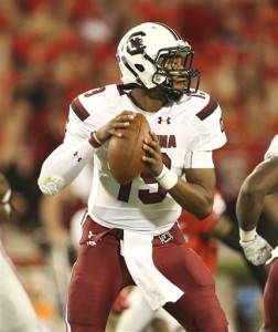 FILE- In tihs Sept. 19, 2015, file photo, South Carolina quarterback Lorenzo Nunez drops back to throw in the second half of an NCAA college football game against Georgia in Athens, Ga. South Carolina will start its third different quarterback Saturday when freshman Lorenzo Nunez takes the field against Central Florida. Nunez replaces Perry Orth, who struggled in a 52-20 loss to Georgia last week after being pressed into duty when a separated shoulder and bruised hip sidelined starter Connor Mitch. (AP Photo/John Bazemore, File)