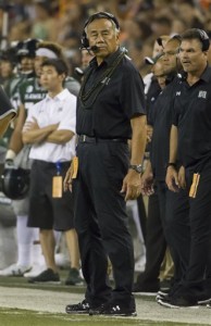 Hawaii head coach Norm Chow glances at the scoreboard as his team plays against Colorado in the third quarter of an NCAA college football game, Thursday, Sept. 3, 2015, in Honolulu. (AP Photo/Eugene Tanner)