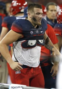 Arizona linebacker Scooby Wright III limps off the field during the first half of an NCAA college football game against UTSA, Thursday, Sept. 3, 2015, in Tucson, Ariz. (AP Photo/Rick Scuteri)