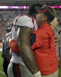 Mississippi defensive tackle Robert Nkemdiche, left, hugs Mississippi head coach Hugh Freeze after a win against Alabama after an NCAA college football game, Sunday, Sept. 20, 2015, in Tuscaloosa, Ala. Mississippi won 43-37. (AP Photo/Brynn Anderson)