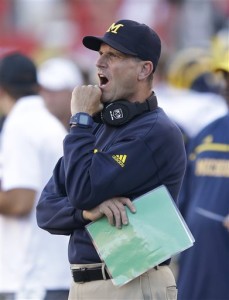 Michigan head coach Jim Harbaugh shouts to his team in the first quarter of an NCAA college football game against Utah, Thursday, Sept. 3, 2015, in Salt Lake City. (AP Photo/Rick Bowmer)