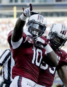 South Carolina's Skai Moore (10) celebrates his interception against North Carolina in the first half of an NCAA college football game in Charlotte, N.C., Thursday, Sept. 3, 2015. (AP Photo/Chuck Burton)