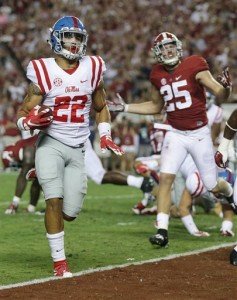 Mississippi running back Jordan Wilkins (22) scores a touchdown during the first half of an NCAA college football game, as Alabama linebacker Dillon Lee (25) watches, Saturday, Sept. 19, 2015, in Tuscaloosa, Ala. (AP Photo/Butch Dill)