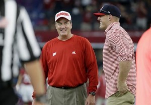 Wisconsin head coach Paul Chryst, left, talks with Houston Texans' J.J. Watt on the field during warm ups before an NCAA college football game against Alabama, Saturday, Sept. 5, 2015, in Arlington, Texas. (AP Photo/LM Otero)