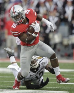 Ohio State running back Ezekiel Elliott escapes the grasp of Western Michigan defensive end Kelon Adams during the fourth quarter of an NCAA college football game, Saturday, Sept. 26, 2015, in Columbus, Ohio. Ohio State defeated Western Michigan 38-12. (AP Photo/Jay LaPrete)