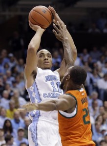 North Carolina's Brice Johnson (11) shoots over Miami's Kamari Murphy (21) during the first half of an NCAA college basketball game in Chapel Hill, N.C., Saturday, Feb. 20, 2016. (AP Photo/Gerry Broome)