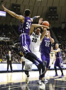 Purdue center A.J. Hammons (20) is fouled by Northwestern guard Sanjay Lumpkin (34) and center Alex Olah (22) in the second half of an NCAA college basketball game in West Lafayette, Ind., Tuesday, Feb. 16, 2016. Purdue defeated Northwestern 71-61. (AP Photo/Michael Conroy)