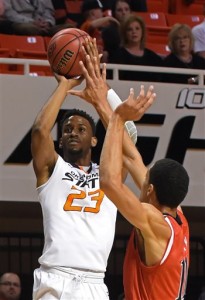 Oklahoma State forward Leyton Hammonds (23) shoots at the basket over Texas Tech forward Zach Smith in the first half of an NCAA college basketball game in Stillwater, Okla., Saturday, Feb. 20, 2016. (AP Photo/Brody Schmidt)