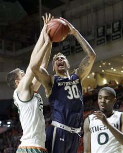 Notre Dame forward Zach Auguste (30) is fouled by as he goes to the basket by Miami forward Ivan Cruz Uceda, left, in the second half of an NCAA college basketball game, Wednesday, Feb.3, 2016, Coral Gables, Fla. Miami won 79-70. (AP Photo/Alan Diaz)