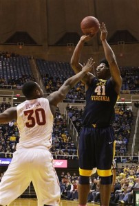 West Virginia forward Devin Williams (41) takes a shot over Iowa State guard Deonte Burton (30) during the second half of an NCAA college basketball game, Monday, Feb, 22, 2016, in Morgantown, W.Va. (AP Photo/Raymond Thompson)