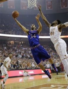 Kansas forward Perry Ellis (34) drives to the basket past Texas center Prince Ibeh (44) during the first half of an NCAA college basketball game, Monday, Feb. 29, 2016, in Austin, Texas. (AP Photo/Eric Gay)