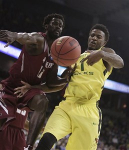 Saint Joseph's forward Papa Ndao, left, and Oregon forward Jordan Bell (1) go after a rebound during the first half of a second-round men's college basketball game in the NCAA Tournament in Spokane, Wash., Sunday, March 20, 2016. (AP Photo/Young Kwak)