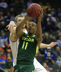 Baylor guard Lester Medford (11) shoots while covered by Texas forward Connor Lammert, back, during the first half of an NCAA college basketball game in the quarterfinals of the Big 12 conference tournament in Kansas City, Mo., Thursday, March 10, 2016. (AP Photo/Orlin Wagner)