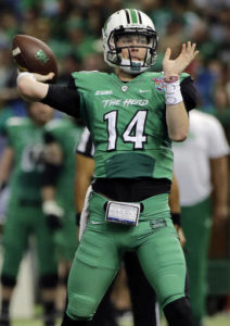 FILE - In this Dec. 26, 2016, file photo, Marshall quarterback Chase Litton throws a touchdown pass to tight during the first quarter of the St. Petersburg Bowl NCAA college football game against Connecticut in St. Petersburg, Fla. Marshall already has seen the best and the worst of quarterback Chase Litton this season, and in order for the Thundering Herd to have a chance against its toughest opponent in a decade, he'll have to rely on what worked in the season opener against an FCS school, not last week's turnover-plagued embarrassment against Akron. (AP Photo/Chris O'Meara, File)